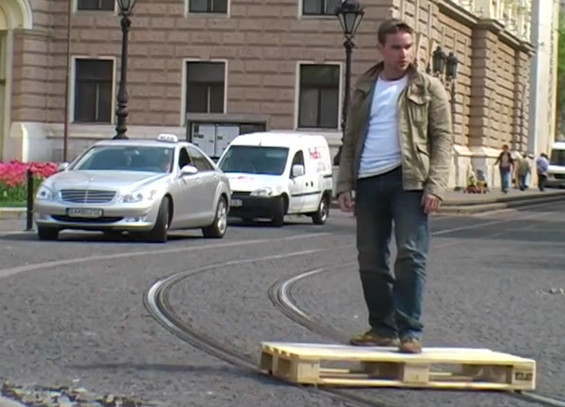 tomas moravec hacks a wooden pallet to glide down tram tracks