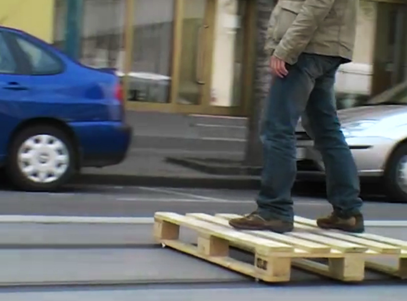 tomas moravec hacks a wooden pallet to glide down tram tracks