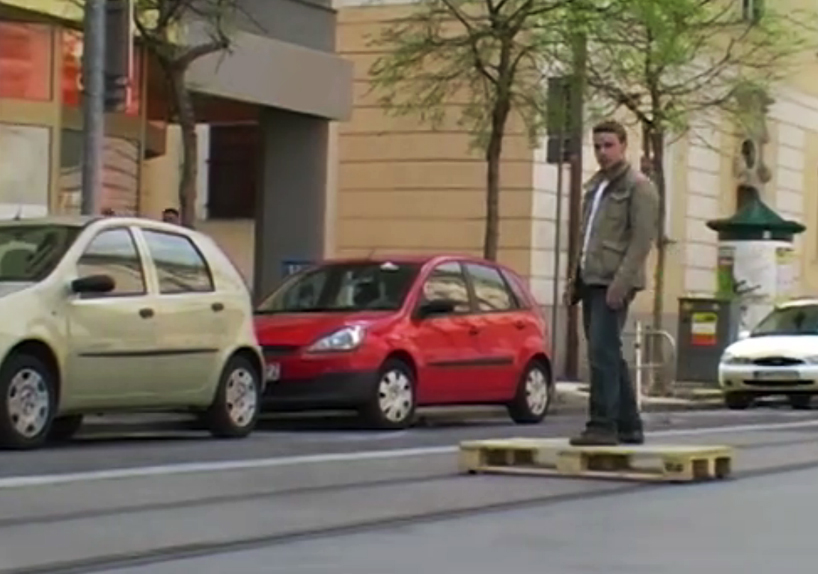 tomas moravec hacks a wooden pallet to glide down tram tracks