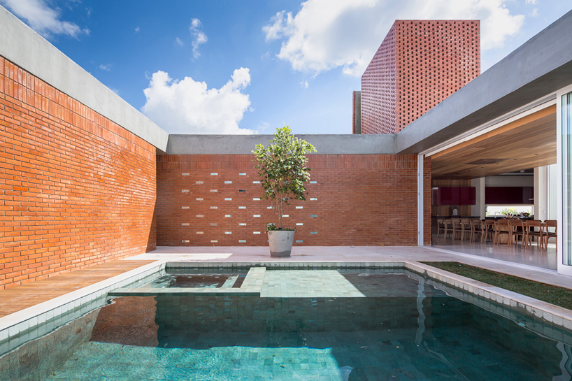 bloco arquitetos articulates brick malva house around secluded pool