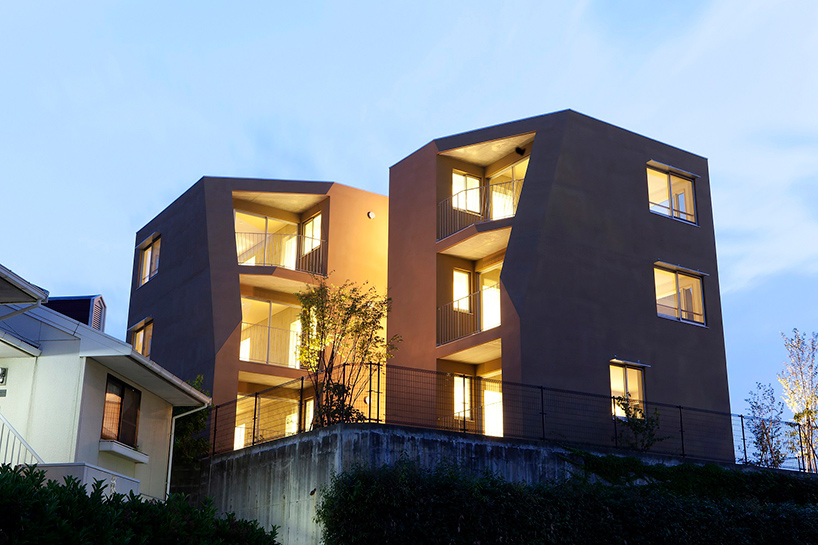 fukuoka apartment complex by tailored design lab weaves between trees