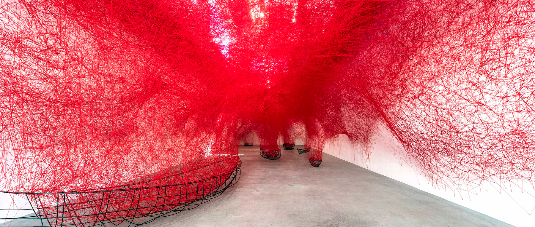 chiharu shiota tethers a labyrinth of red yarn to boat carcasses at blain|southern