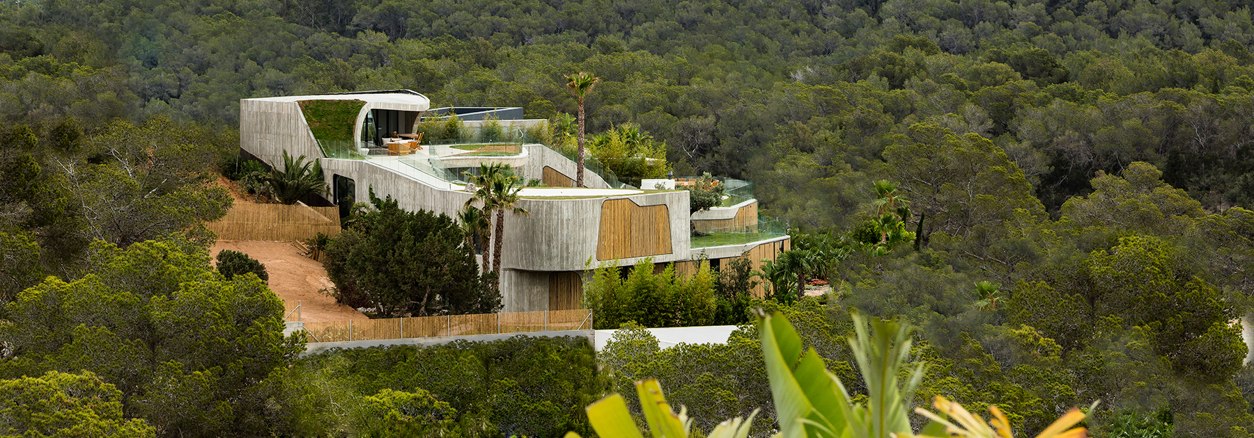 metroarea architetti clads villa in ibiza with board formed concrete and bamboo shutters