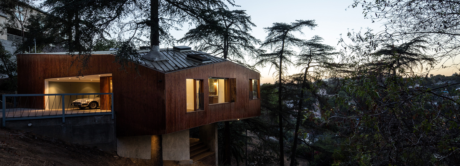 cantilevered dwelling by anonymous architects exists amid the trees in los angeles