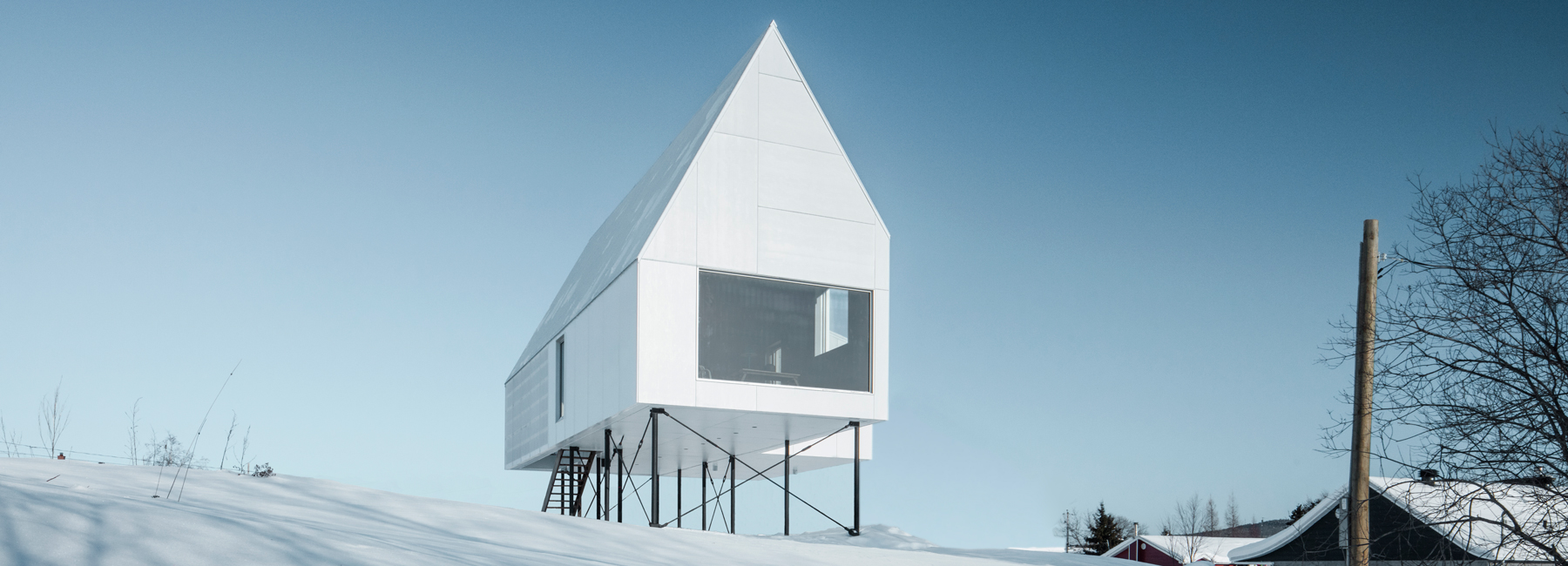 delordinaire elevates high house above snow-covered landscape in quebec