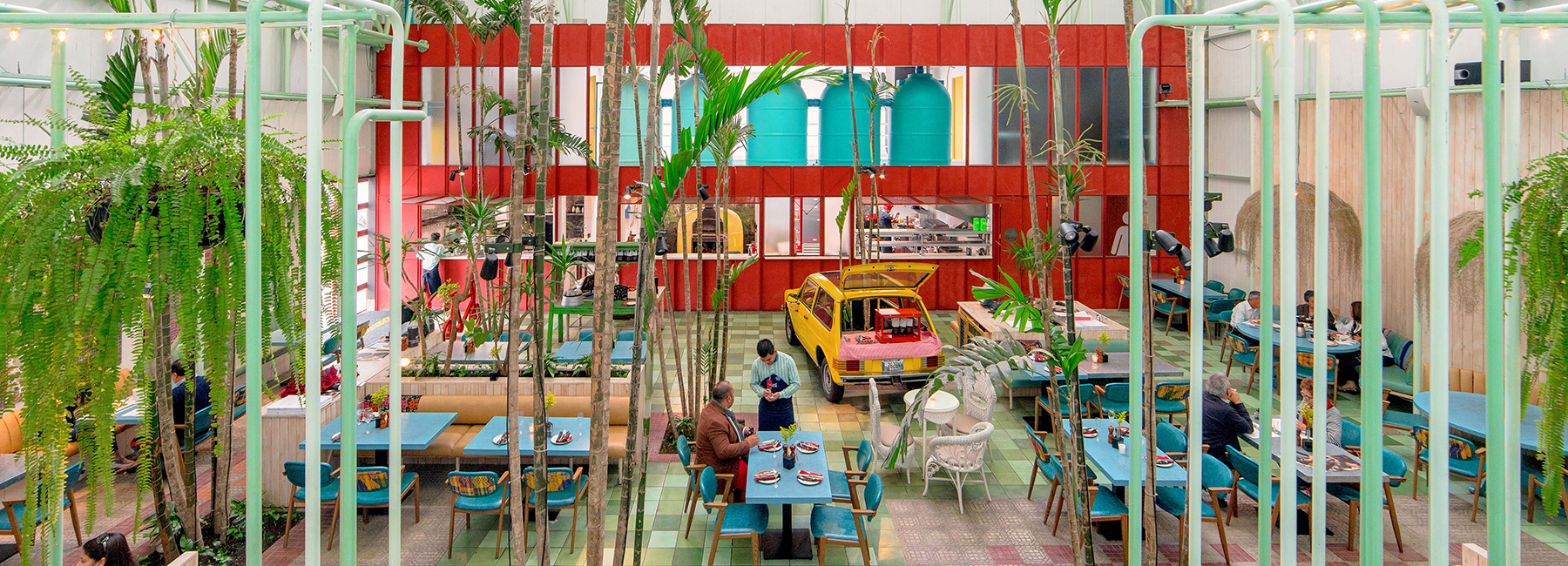 taller KEN populates madero café in guatemala with tropical planting and vintage cars