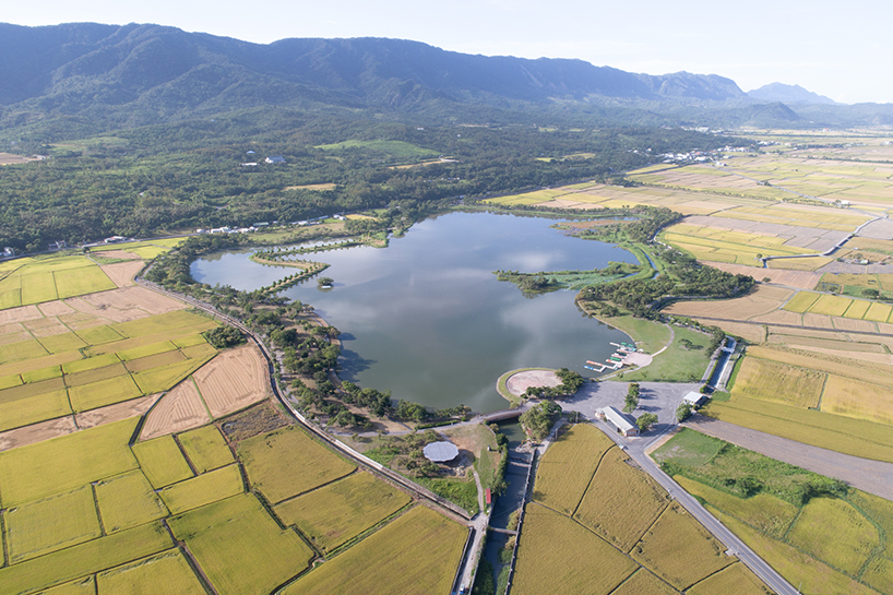tie-ma cycling station with metal lotus roof floats next to taiwan's dapo pond