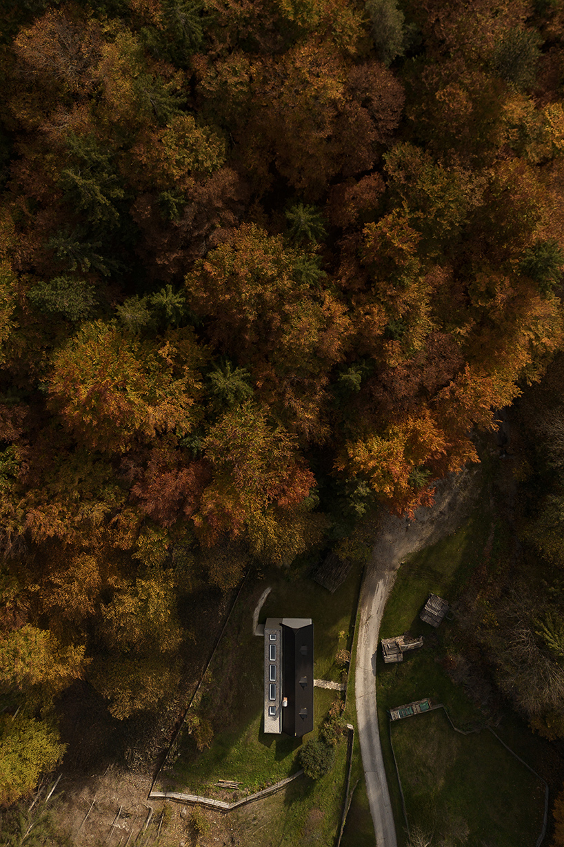 two-centuries old farmhouse and contemporary extension face off in austrian hillscape