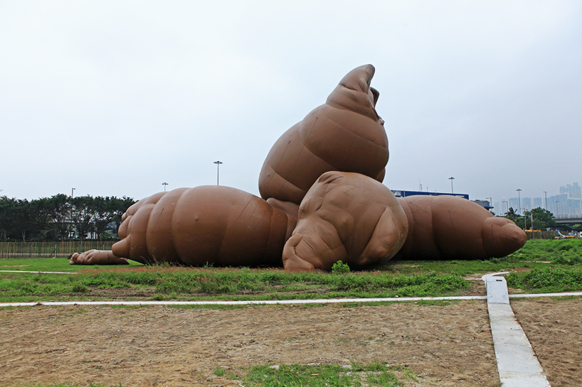 giant inflatable pile of poo, roast pig and stonehenge sculptures at M+