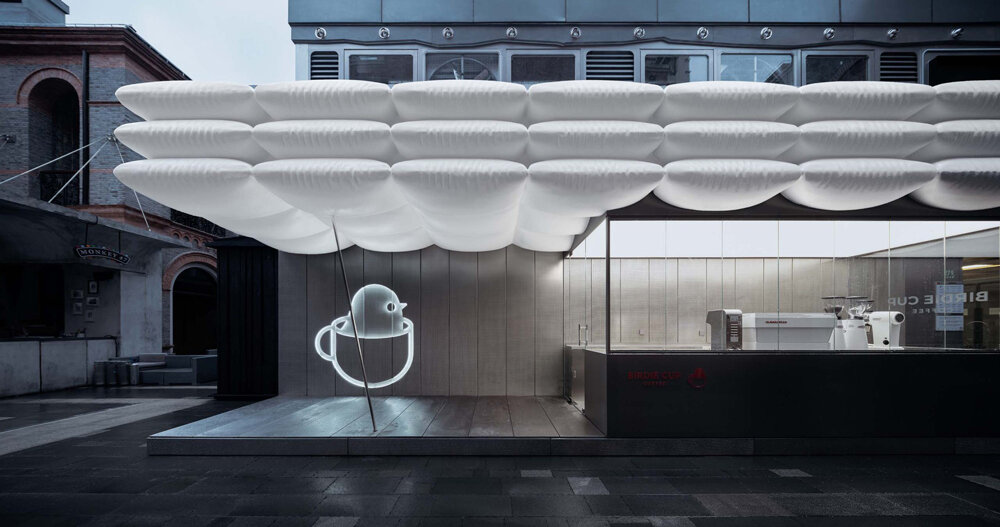 F.O.G. architecture's birdie cup coffee nested beneath floating white puffs
