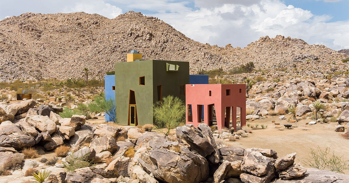 emerging from the rugged joshua tree desert, colorful 'monument house