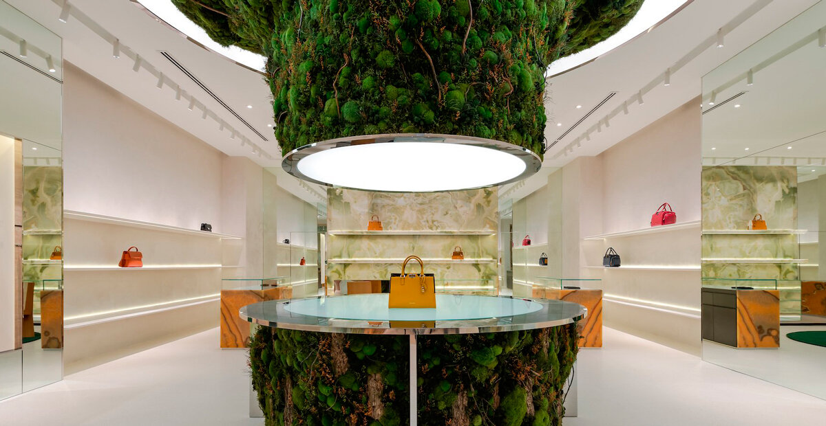 tree installation sprouts from the floor to display leather goods