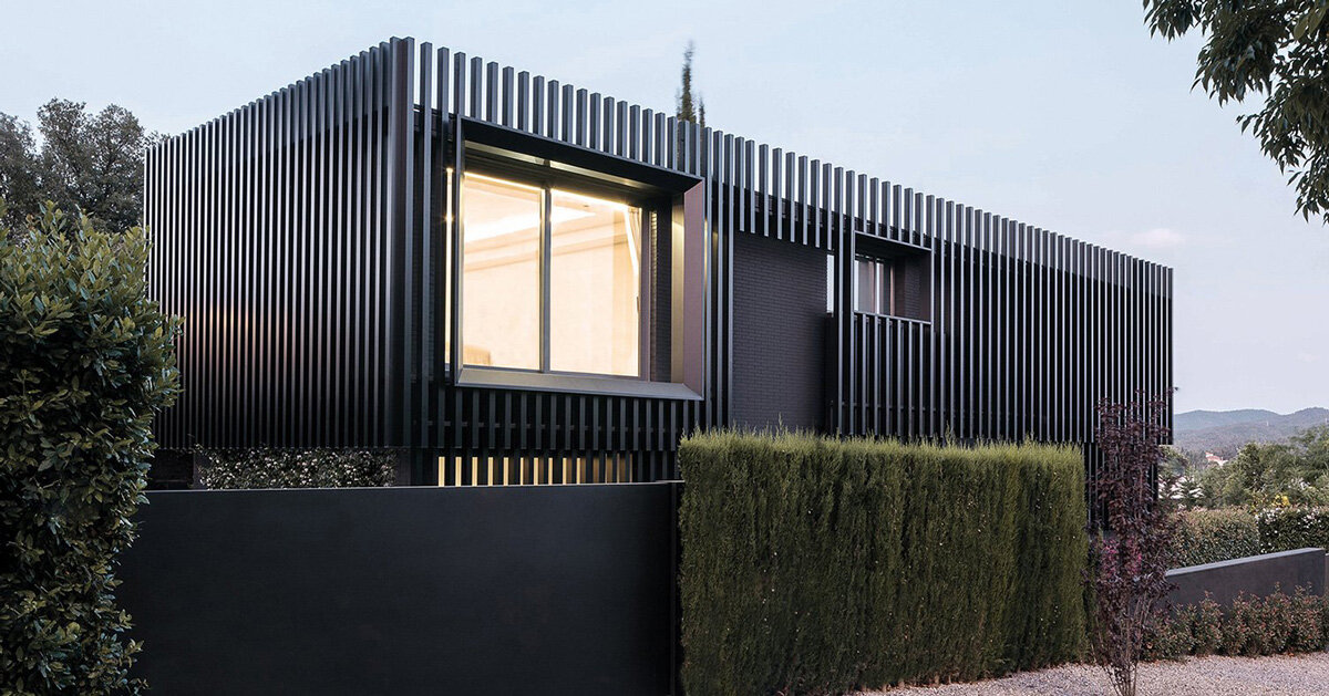 monochrome envelop of black and vertical steel slats modernize family home in barcelona