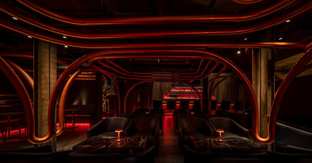 bangkok bar disguised as pawnshop indulges visitors in ambient lighting and sculptural loops