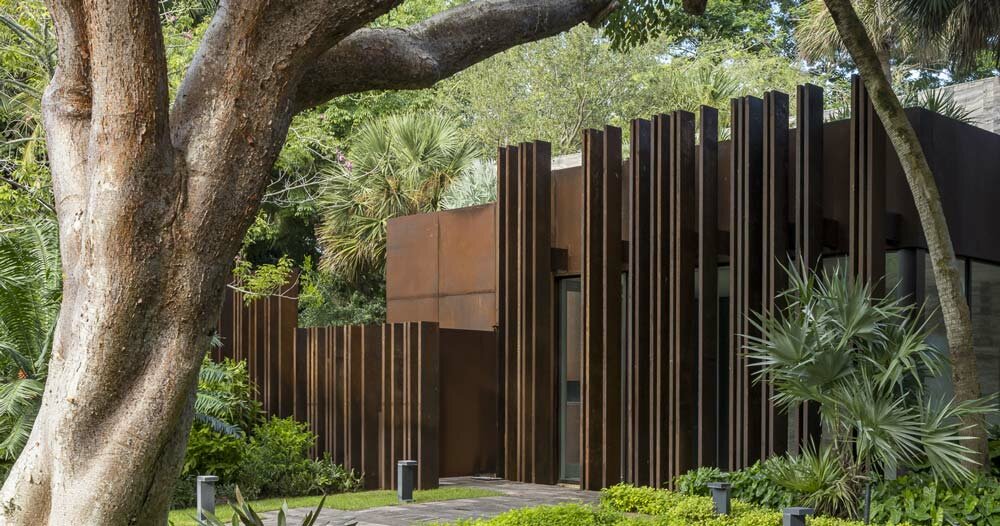 corten steel gatehouse overgrown by tropical nature in coconut grove, miami