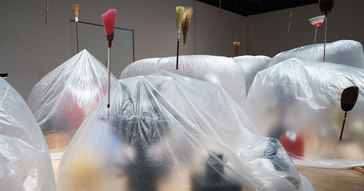 yasuaki onishi's installation wraps sculptures in breathing sheet bag