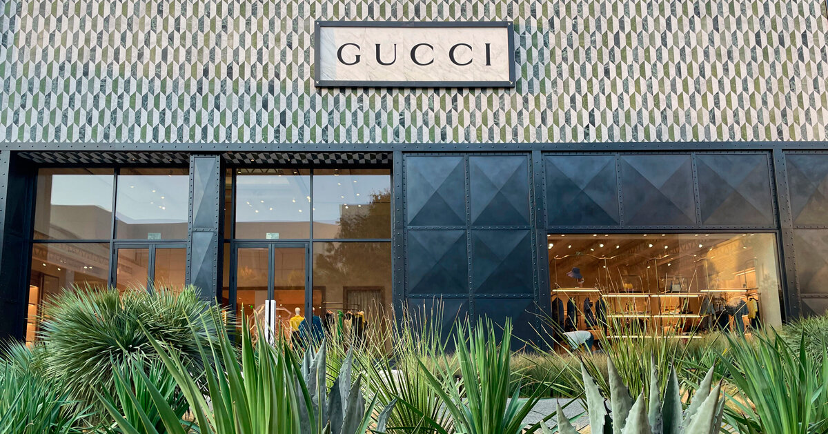 planting design by nomad studio reflects gucci store's facade in texas