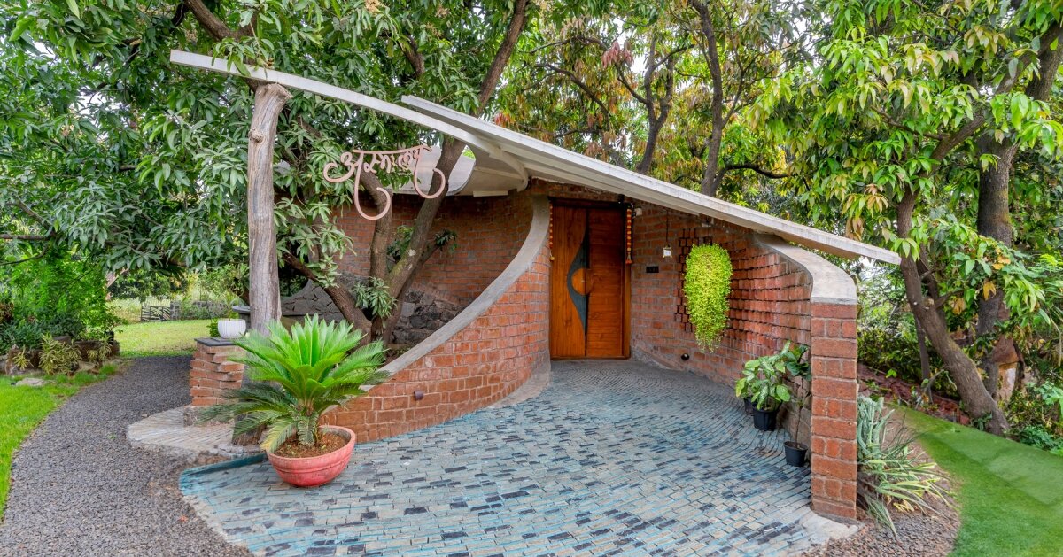curved brick walls wrap biophilic farmhouse by blurring boundaries in ...