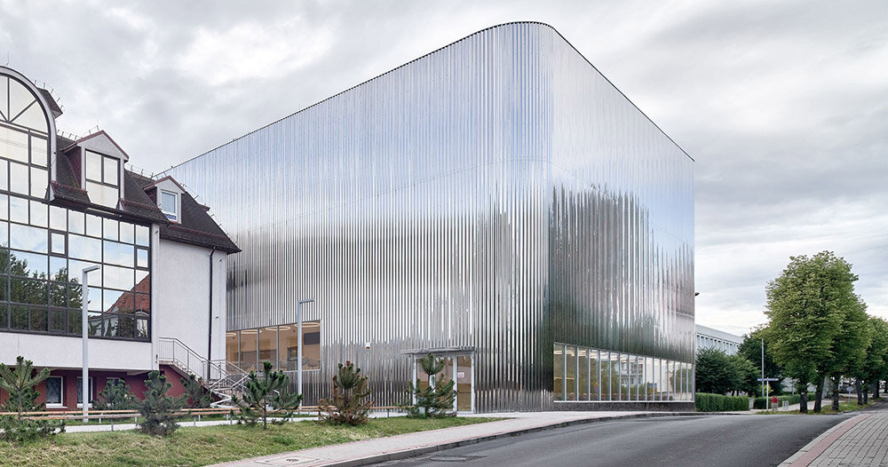 SLAS architekci wraps concert hall in poland with shimmering steel facade
