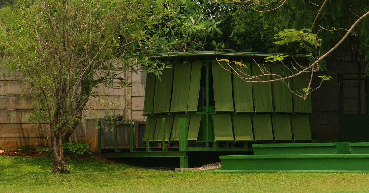 modular steel grid and green fabric panels shape temporary kitchen pavilion in java
