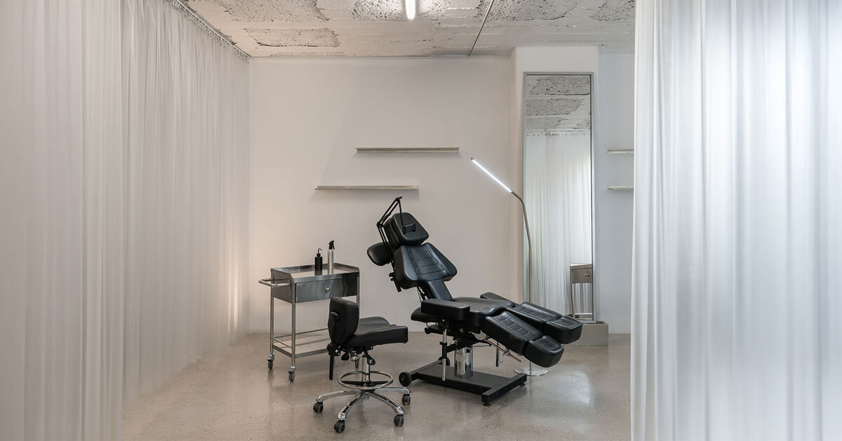 blok tattoo studio in barcelona redefines sterile spaces through concrete and steel interiors