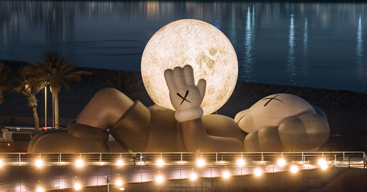 32-meter companion by KAWS lifts glowing moon along abu dhabi’s waterfront