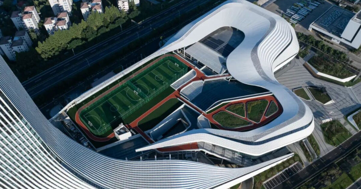 aluminum panels wrap landscape-inspired undulating facade of sports mall by line+