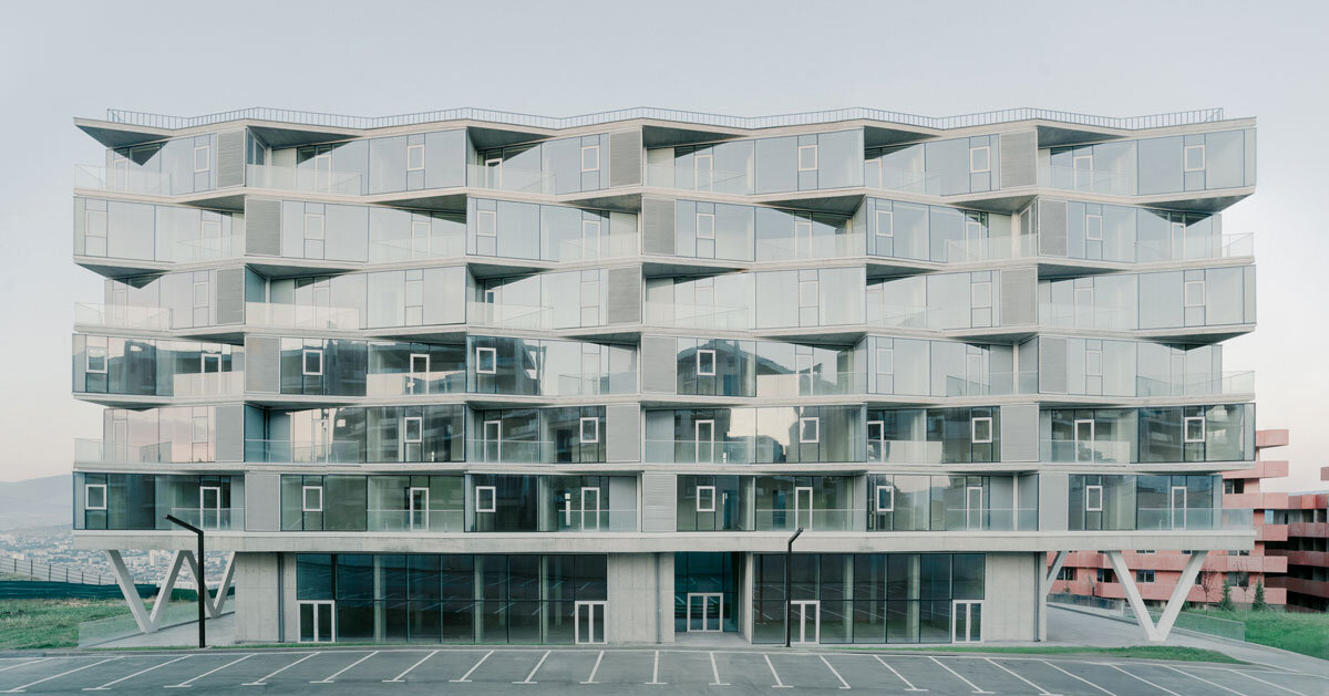 prismatic glass facade enfolds residential unit's concrete modular framework in georgia