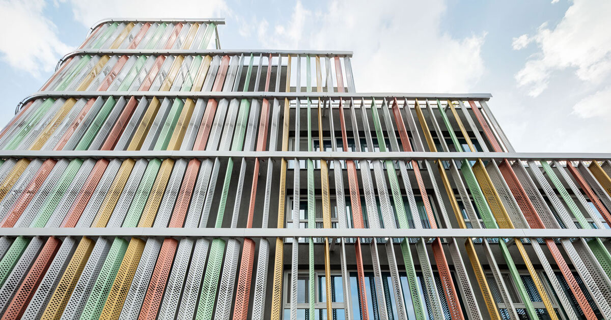 translucent facade of multicolored steel louvers unfolds along seoul's dokkaebi market