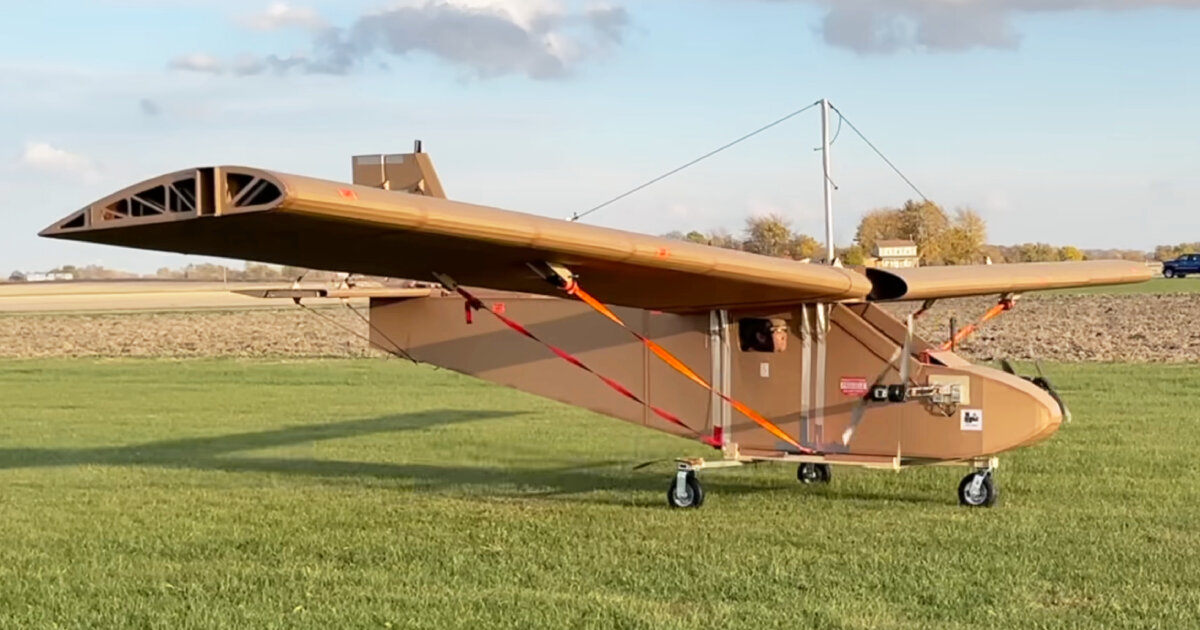 cardboard airplane with wooden wings takes flight using remote control