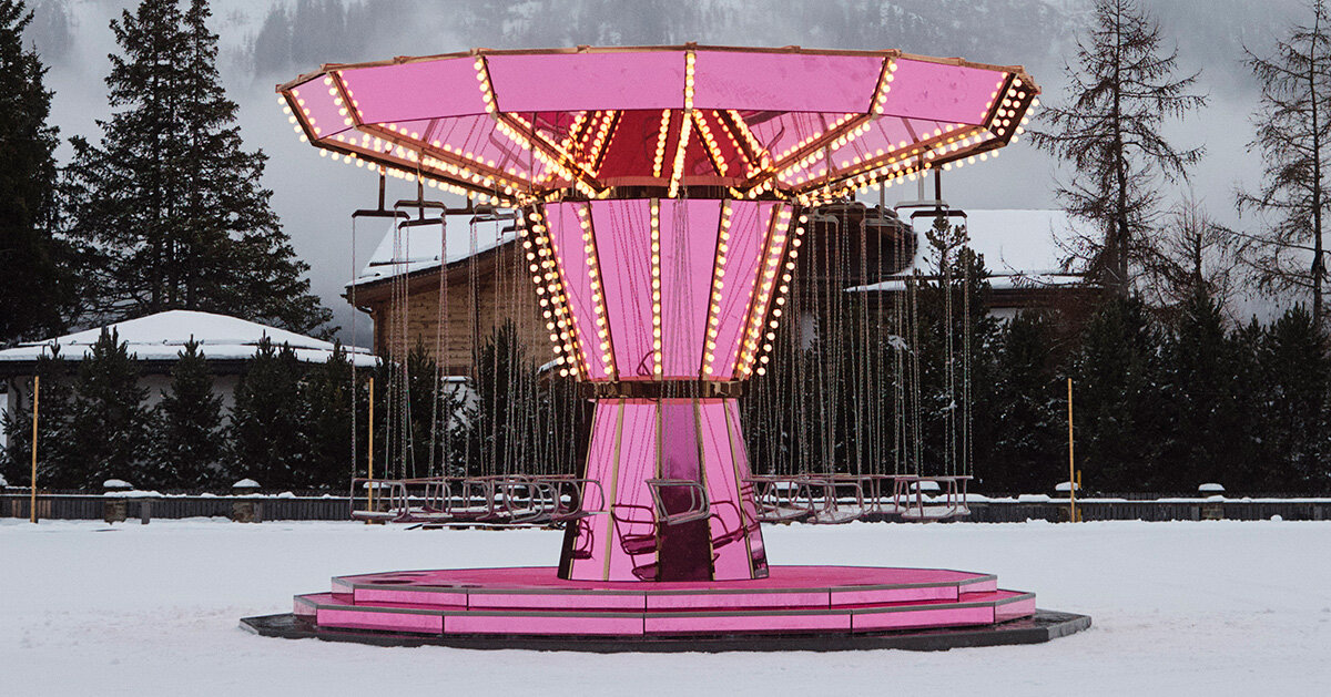 carsten holler's pink mirrored carousel slows time on the ice rink of the kulm hotel st. moritz