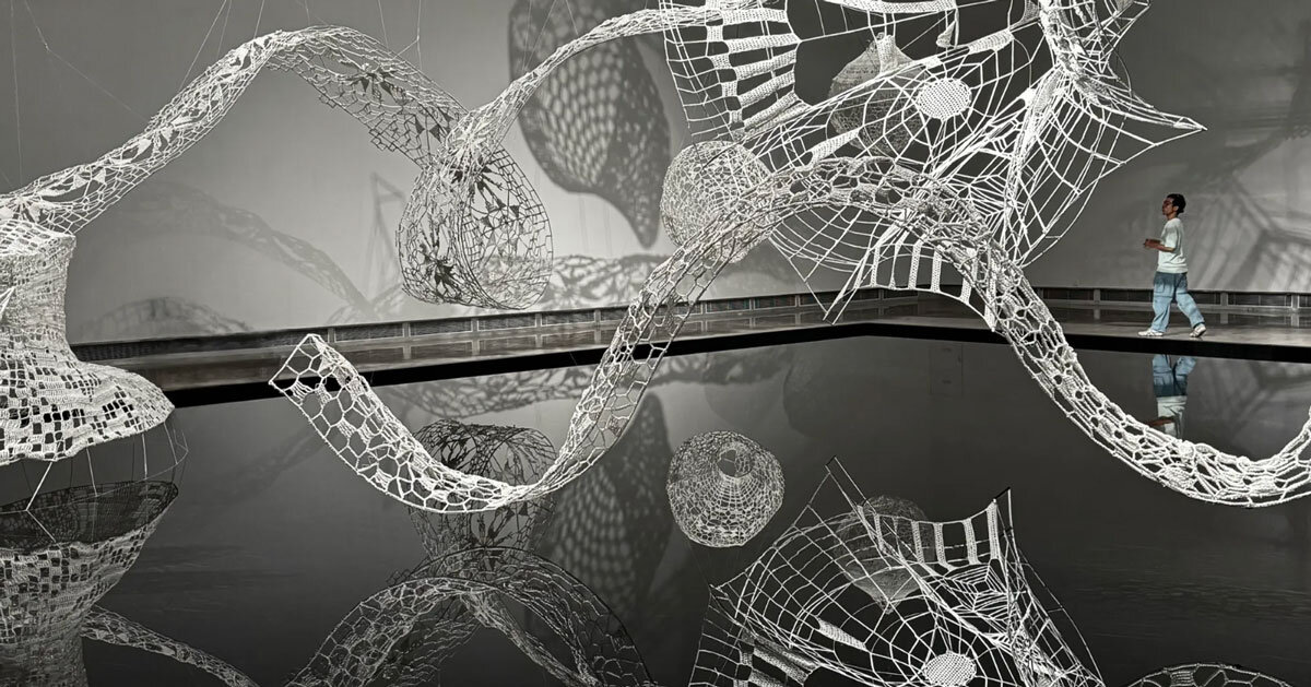 crocheted zodiac animal installations by choi+shine suspend above dark body of water