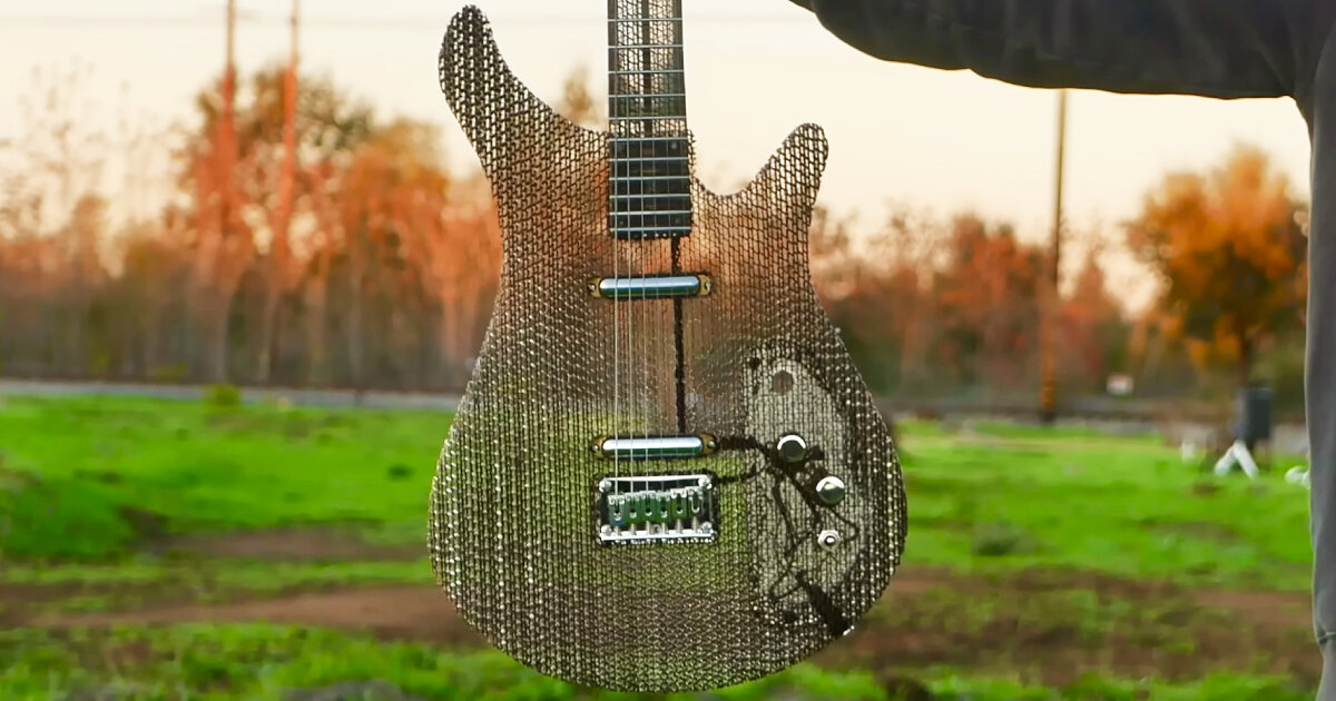 electric guitar made of air and recycled cardboard plays as functional musical instrument