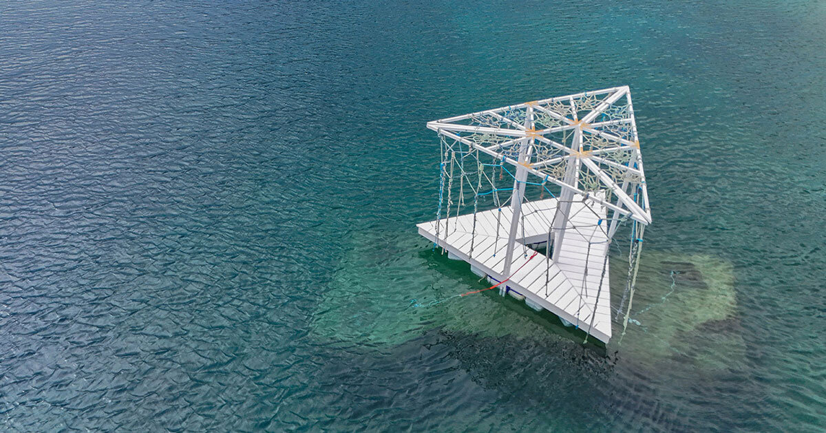 triangular wooden pavilion floats on reused plastic gallons along croatia's coasts