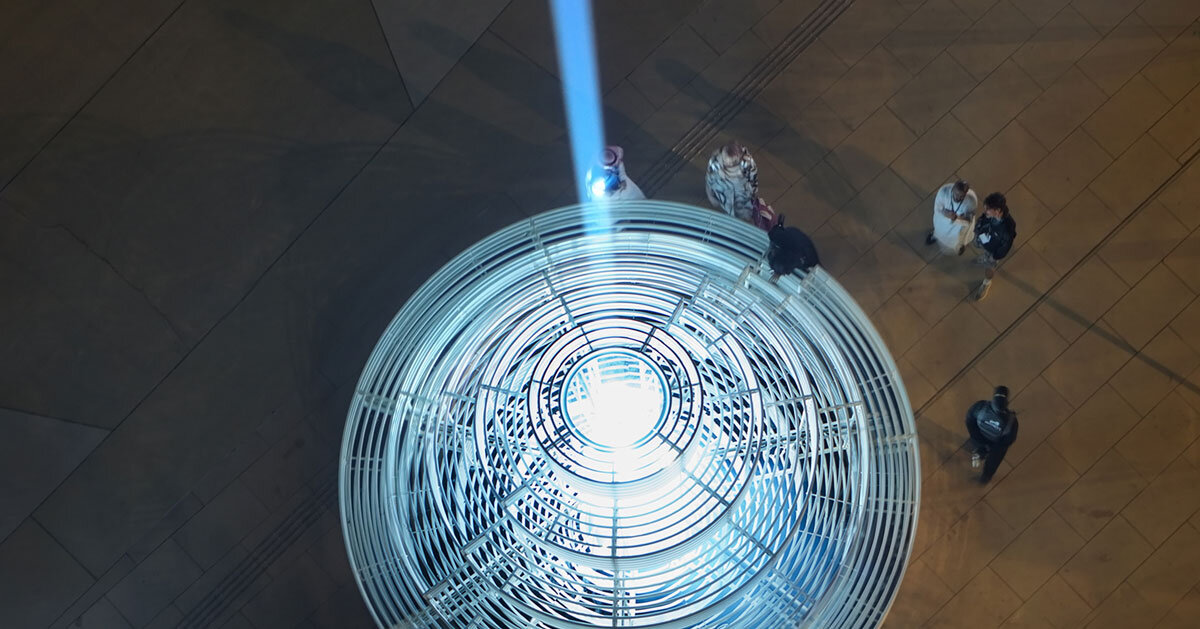 reflective pyramidal monument emits sky-tracing beam of white light in saudi arabia