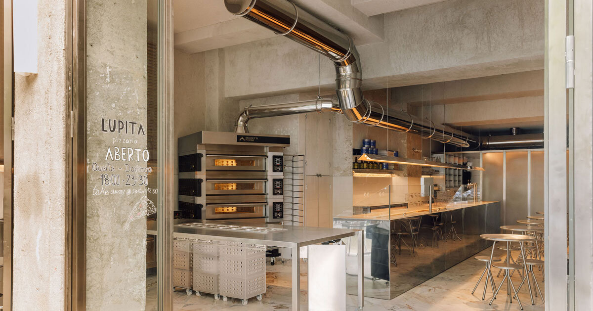 reflective steel interiors and open facade bring lisbon’s street activity into pizza restaurant
