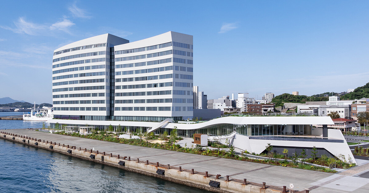 curved twin volumes shape the risonare shimonoseki hotel along japan's kanmon strait