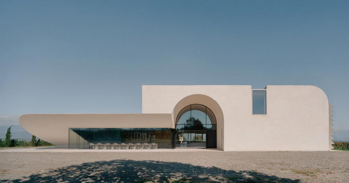 arches and voids carve winery’s monolithic white facade in georgia