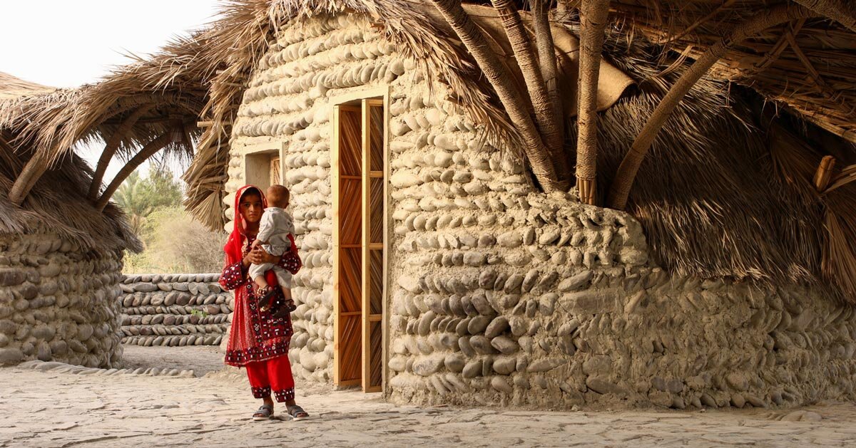 vaulted palm canopy shields dry stone guesthouse cluster in southeastern iran