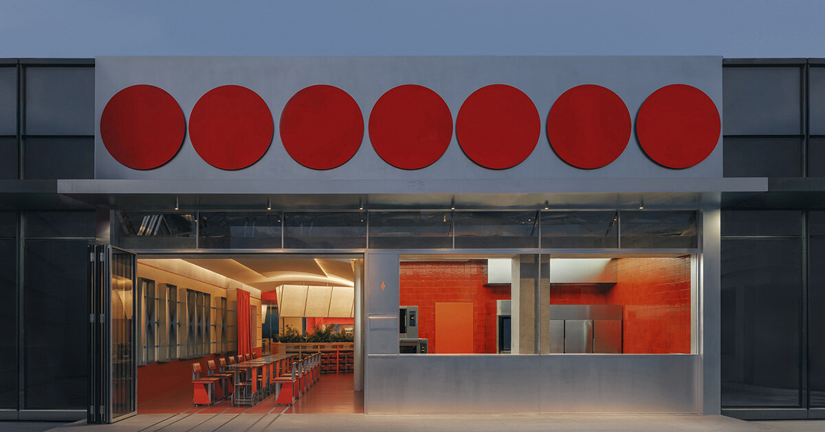 row of circular red panels lines the facade of café on-site by aptdotapt in china