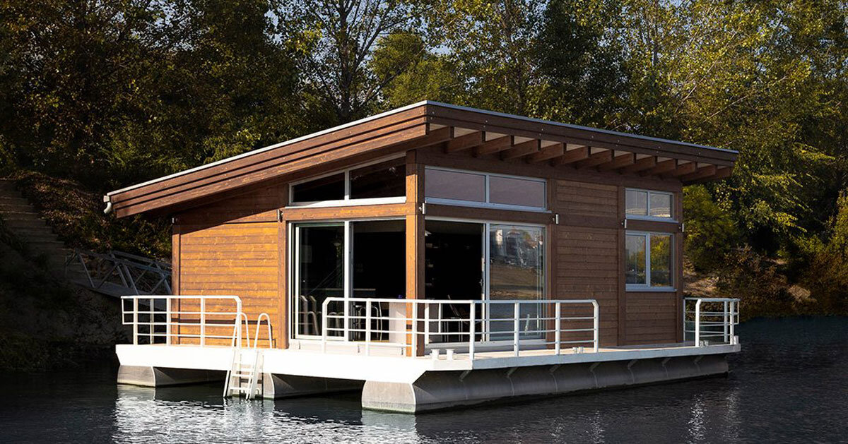 mono-pitch roof shields compact wooden cabin floating along river in serbia