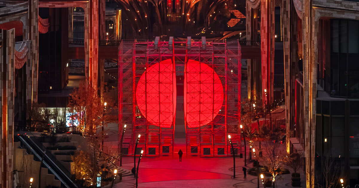 SpY's monumental divided sphere installation illuminates xi'an in bright red light