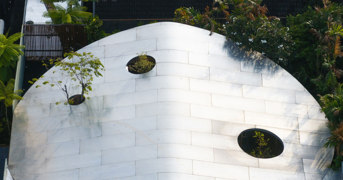 curved glass atriums penetrate residence’s aluminum roof in bangkok