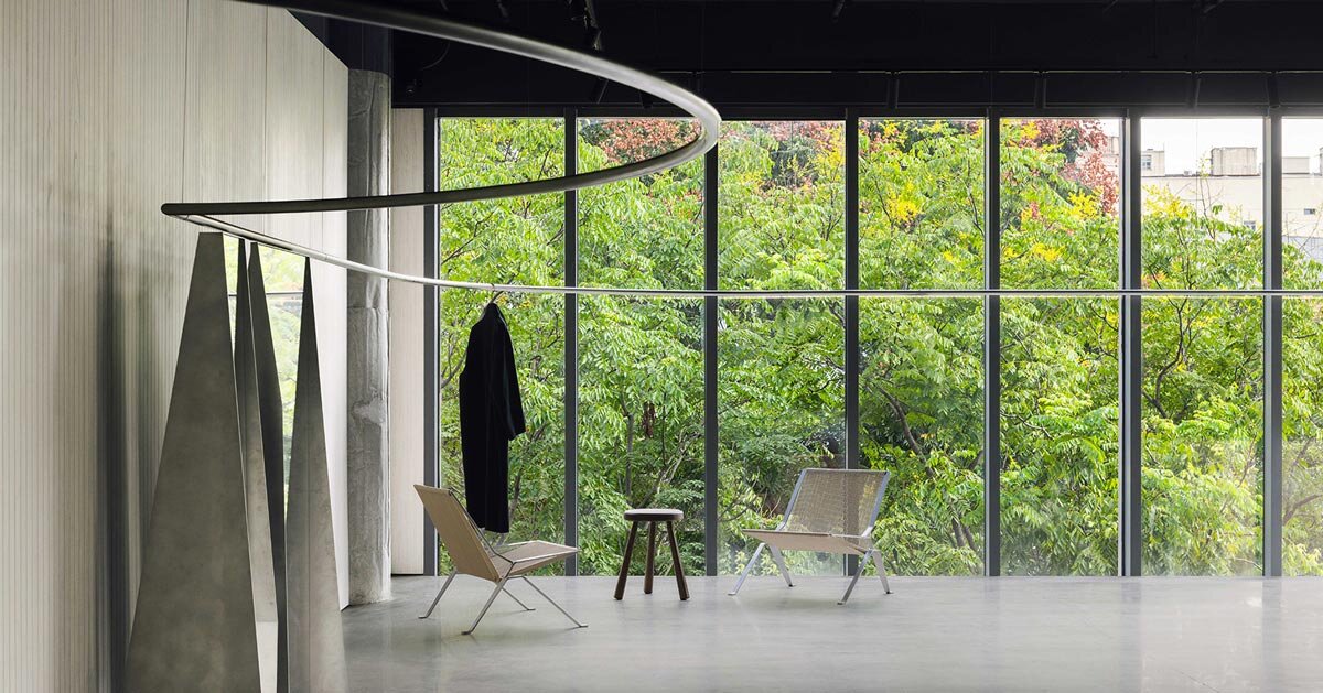 continuous steel rail traces shanghai showroom's sculptural interior, like a freehand drawing