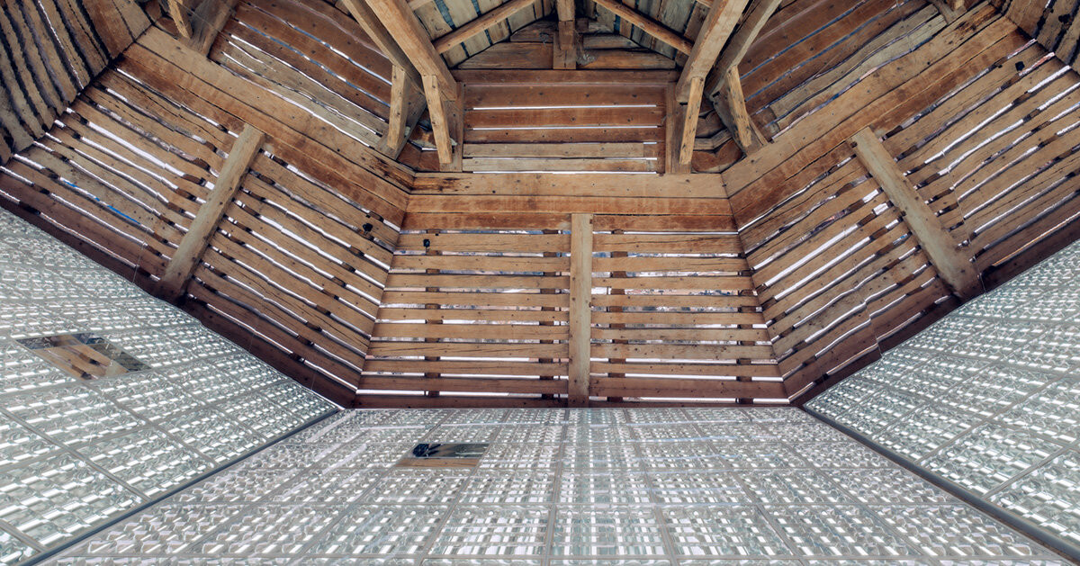 alexandre de betak inserts reflective light installation into traditional swiss barn