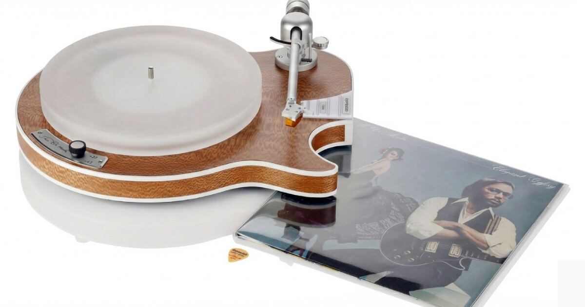 electric guitar-shaped turntable spins vinyl records on frosted platter and wooden base