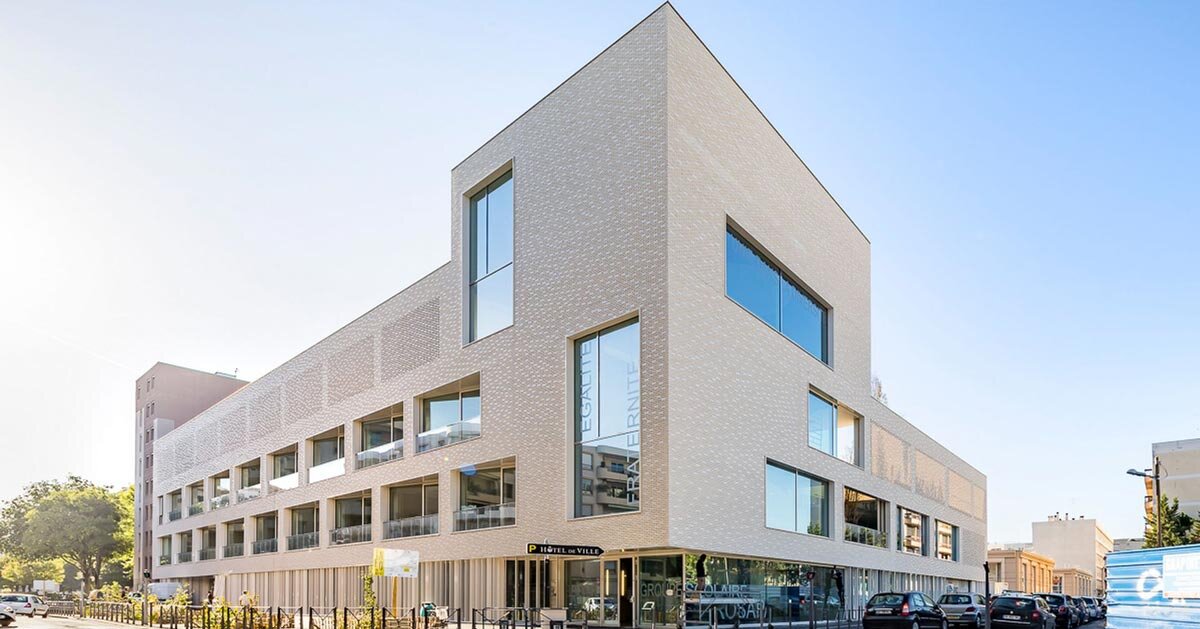 stepped white brick facade wraps school group in france by brenac & gonzalez & associés