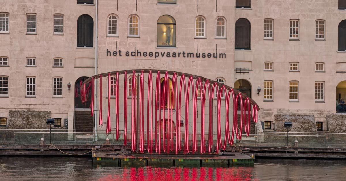whale skeletal light installation glows red for amsterdam light festival