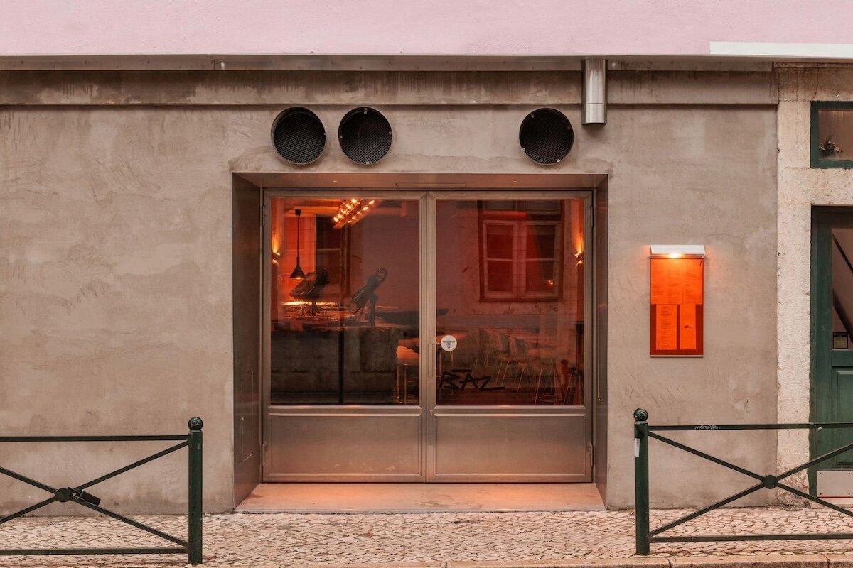 xxxi.studio divides lisbon restaurant with 15 meter long charred wood counter