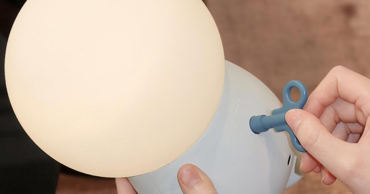 buddy portable mood lamp encourages interaction through a single wind-up key